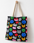 A colorful cat face tote bag hanging on the wall.