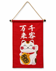 A Lucky Cat wall hanging featuring the Japanese phrase “Senkyaku Banrai.”