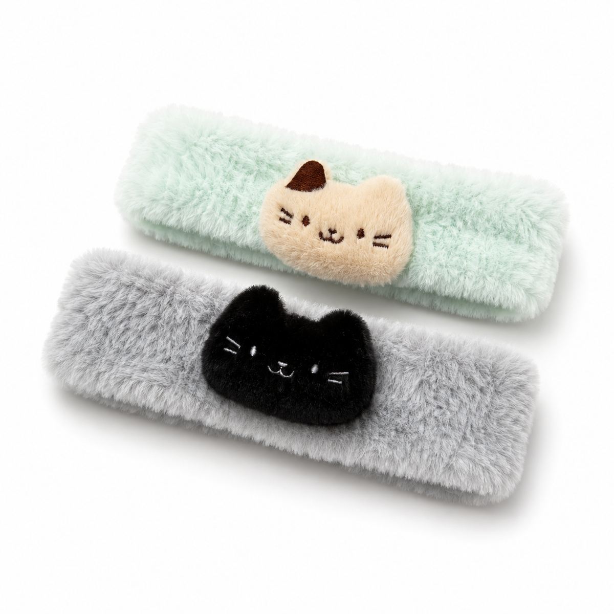 Soft and fluffy cat spa headbands in mint green with a cream cat and soft gray with a black cat.