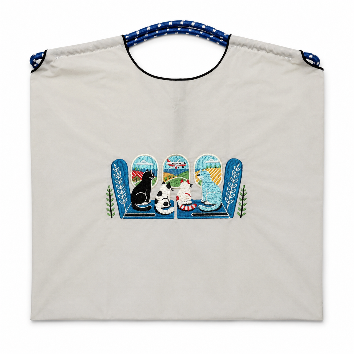 Gray Cats by the Window tote bag with four cats, colorful scenery, an airplane, and blue rope-style handles.
