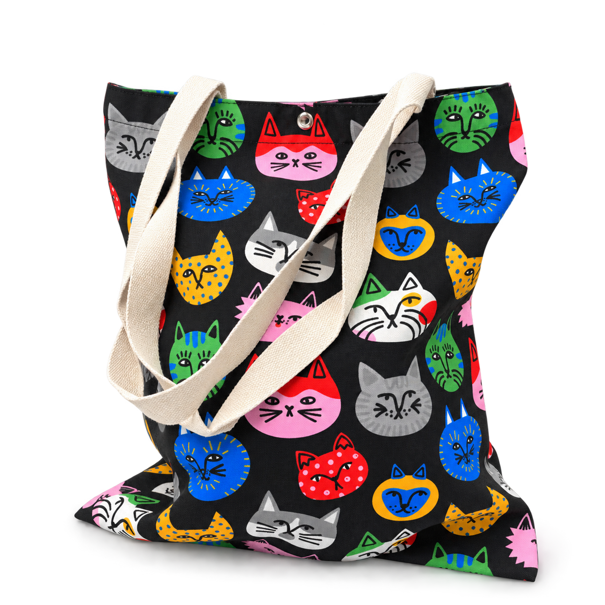 A colorful cat face tote bag filled with items, showing its roomy shape and everyday carrying capacity.