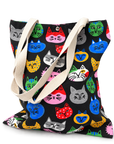 A colorful cat face tote bag filled with items, showing its roomy shape and everyday carrying capacity.