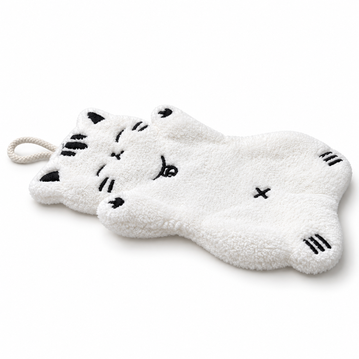 Side view of the white full-body cat-shaped hand towel, showing its thickness, soft texture.