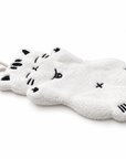 Side view of the white full-body cat-shaped hand towel, showing its thickness, soft texture.