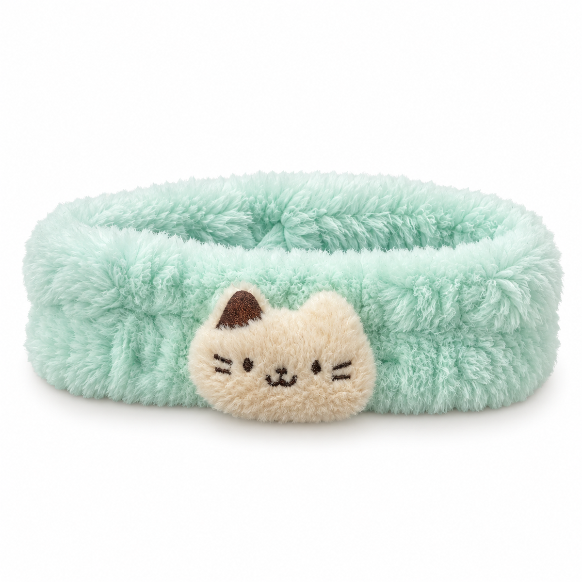 Soft and fluffy mint green spa headband with a cream cat face appliqué in the center.